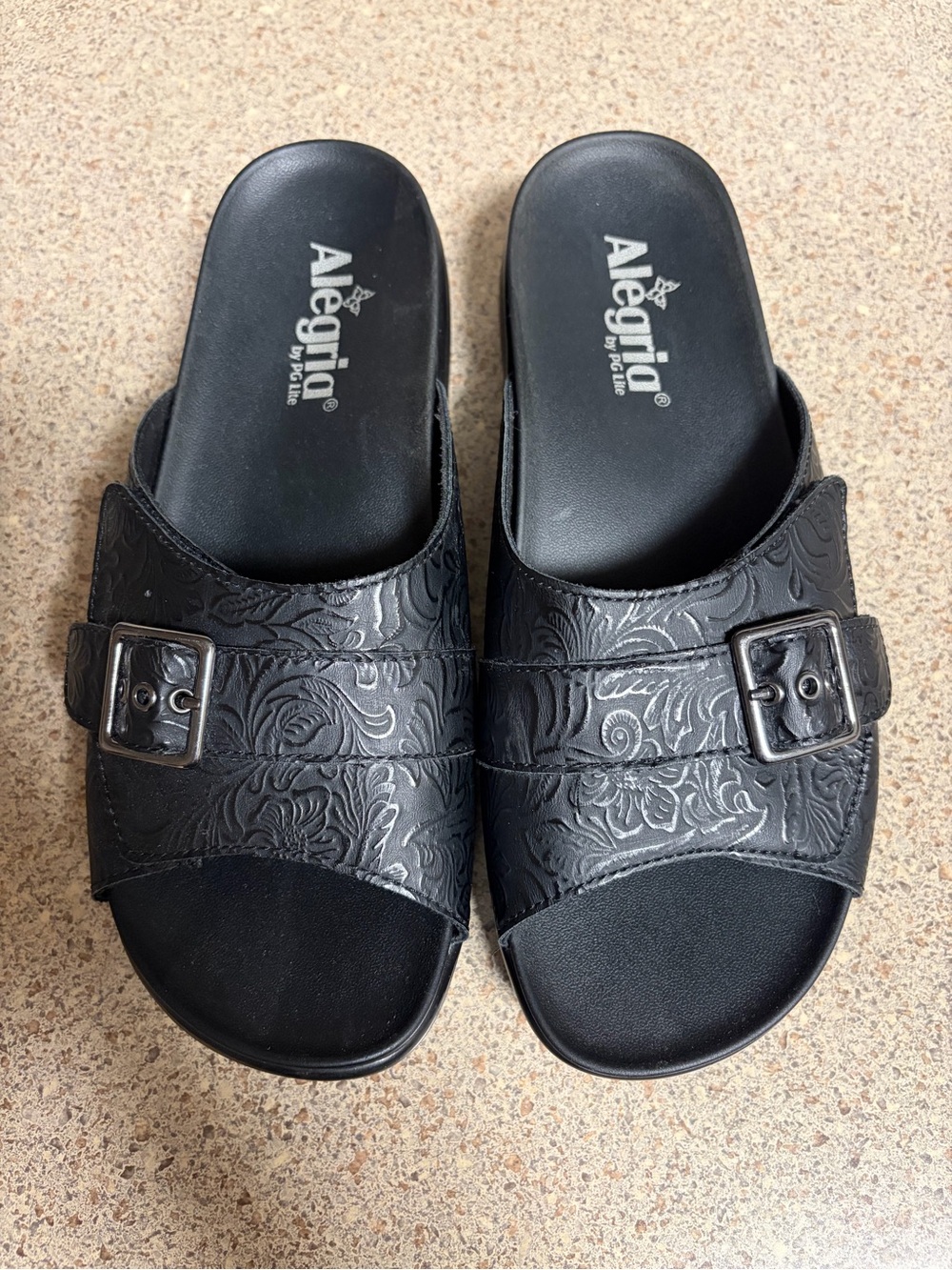 Alegria Black Embossed Buckle Slide Sandals with Floral Detail